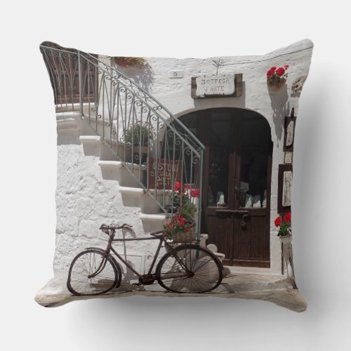 Old bike and storefront in Apulia Throw Pillow