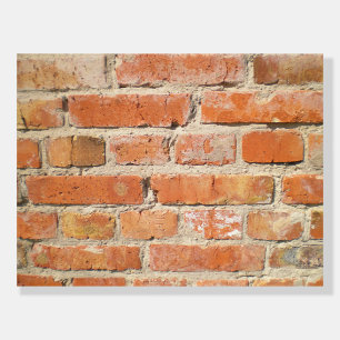 Old brick wall with peeling cladding foam board