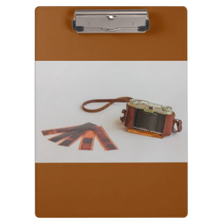 old camera with negative on clipboard