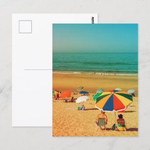 Old couple under beach umbrella in Fonte da Telha. Postcard