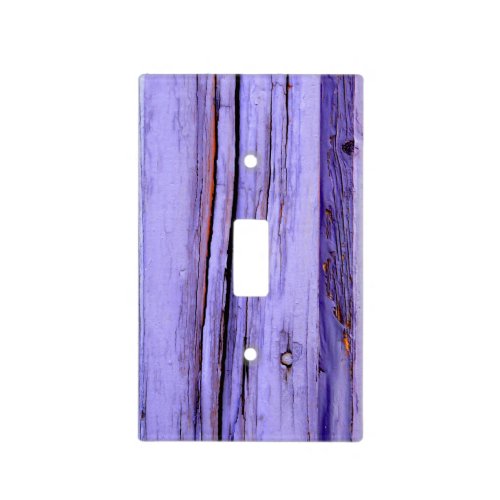 Old cracked purple paint on wood light switch cover