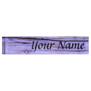 Old cracked purple paint on wood name plate