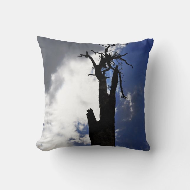 Old dead tree against dark cloudy sky throw pillow (Front)