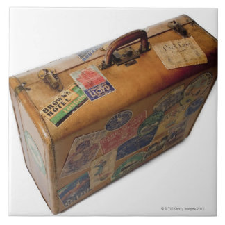 old fashioned suitcase with travel stickers ceramic tile