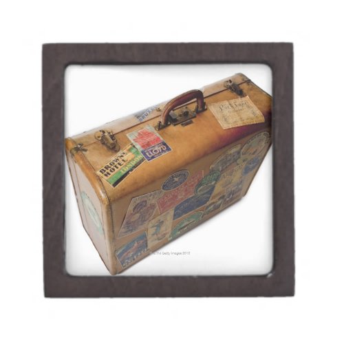 old fashioned suitcase with travel stickers gift box