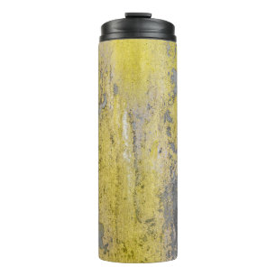 Old gray concrete wall with peeling yellow paint. thermal tumbler