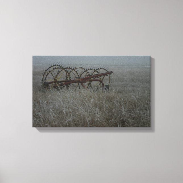 Old hay rake farm equipment in the winter frosty canvas print (Front)