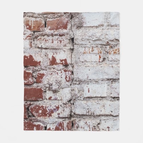 Old painted brick wall with peeling white paintwal fleece blanket