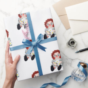 old rag doll with daisy bouquet wrapping paper