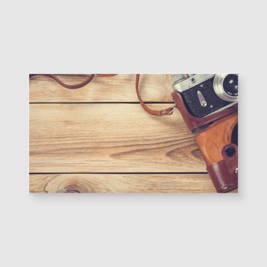 Old Retro Camera On Wooden Table Background (Front)