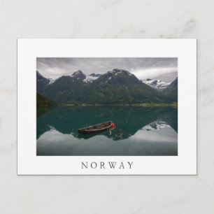Old rowboat and mountains in Norway white postcard