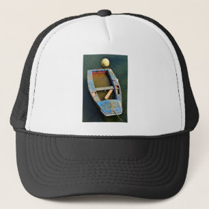 Old small boat with a seagull trucker hat