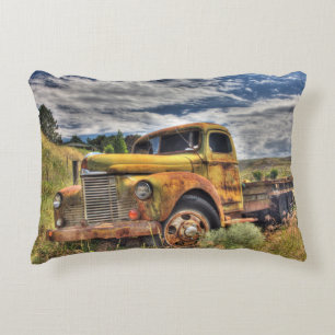 Old truck abandoned in field decorative pillow
