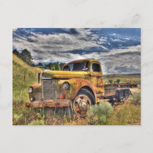 Old truck abandoned in field postcard
