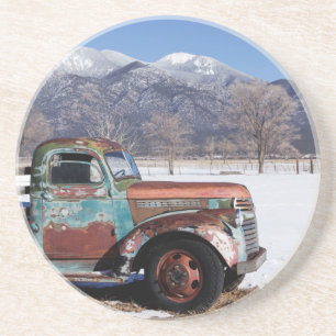 Old truck sitting in the field coaster