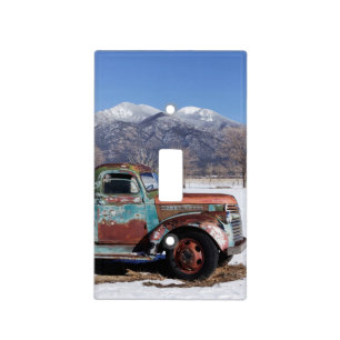 Old truck sitting in the field light switch cover