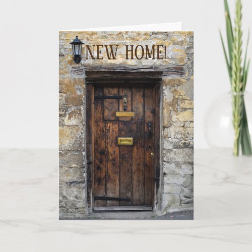 Old wooden front door with light new home card