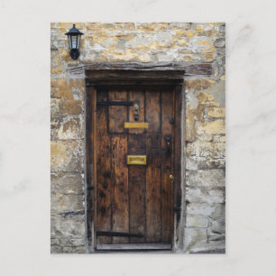 Old wooden front door with light postcard