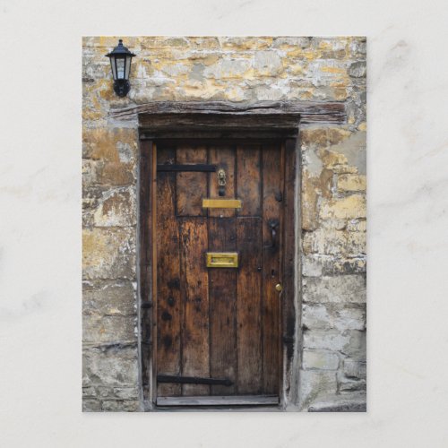 Old wooden front door with light postcard