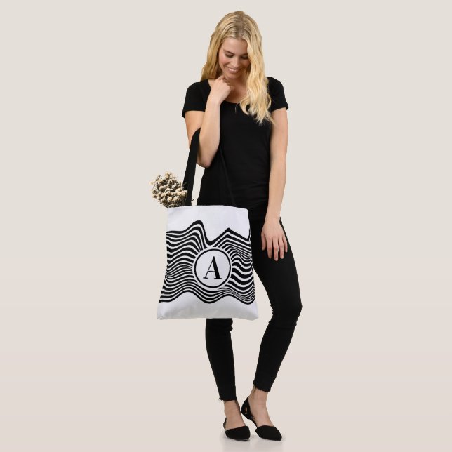 Op art with black and white wavy lines and letter tote bag (On Model)