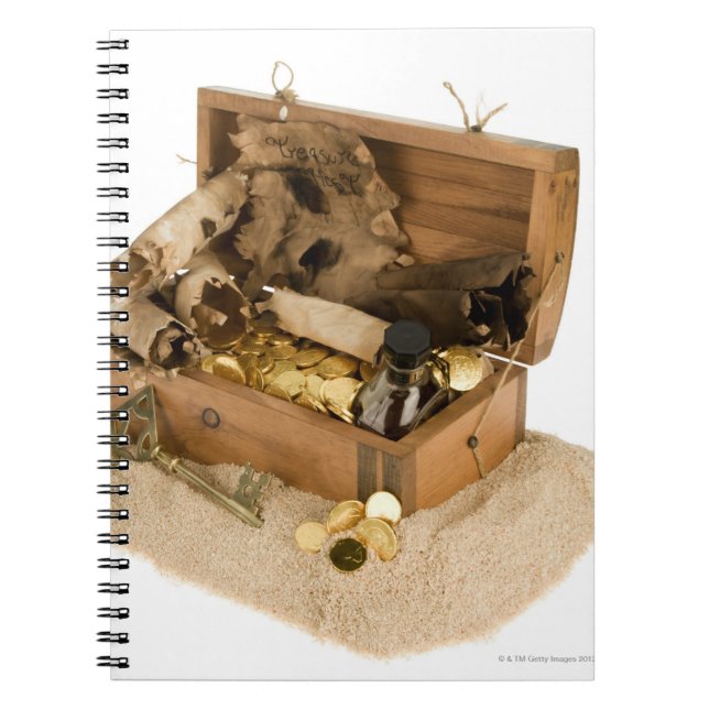 Open replica of treasure chest on sand notebook (Front)
