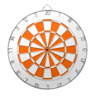 orange and white dartboard with darts