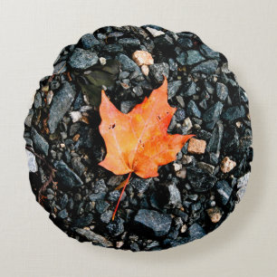 Orange Autumn Leaf on Black Rocks Round Pillow