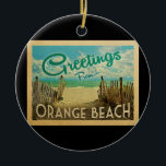 Orange Beach Vintage Travel Ceramic Ornament<br><div class="desc">This Greetings From Orange Beach vintage postcard design features a sandy beach with a beautiful turquoise ocean water and above the sea,  a blue sky with billowy white clouds. In vintage travels style.</div>
