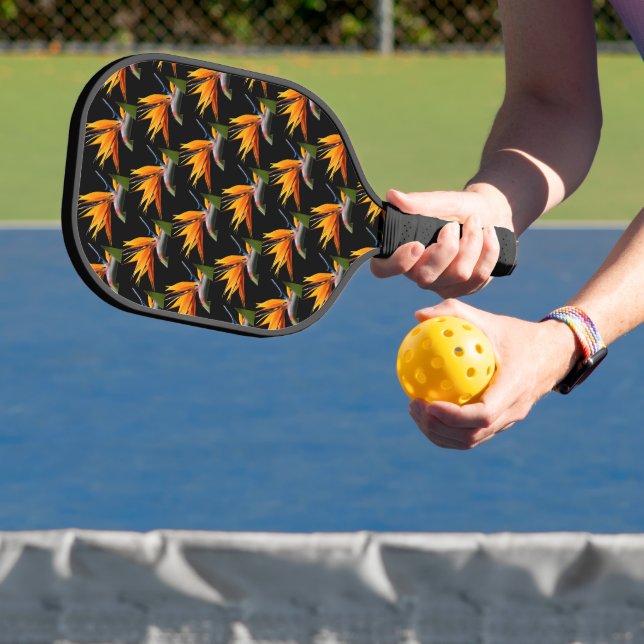 Orange Bird of Paradise Plant Pattern on Black Pickleball Paddle (Insitu)