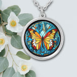 Orange Butterfly Blue Stained Glass Silver Plated Necklace<br><div class="desc">On this unique necklace is the image of a beautiful orange and gold butterfly against a stained glass style background. The background and border are in tones of blue. Elegant,  bright,  and colorful! Be sure to see the matching earrings and key chain in our store.</div>