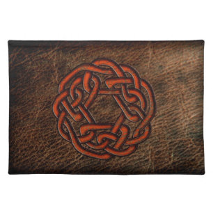 Orange celtic knot on leather placemat