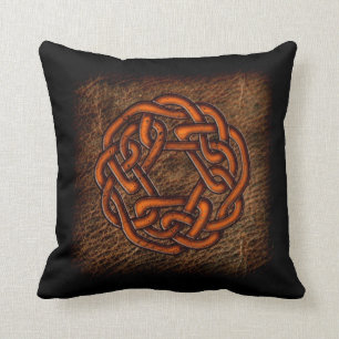 Orange celtic knot on leather throw pillow