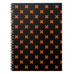 Orange cross stitches on black notebook