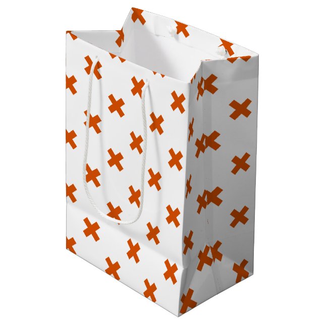 Orange cross stitches on white medium gift bag (Front Angled)