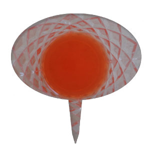 Orange drink inside a crystal glass cake topper
