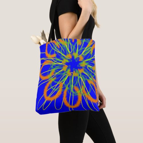 Orange geometric flower on blue tote bag