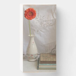 Orange gerbera and books  wooden box sign