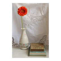 Orange gerbera and old books