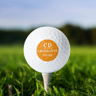 Orange monogrammed name golf balls
