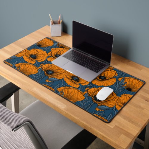 Orange poppies on dark blue desk mat
