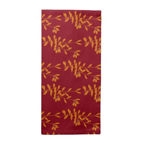 Orange silhouette branch leaves on red cloth napkin