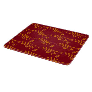 Orange silhouette branch leaves on red cutting board