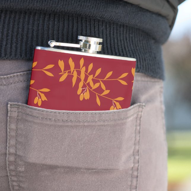 Orange silhouette branch leaves on red flask (In Situ)
