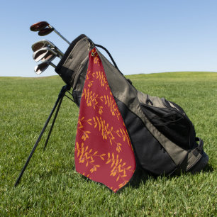 Orange silhouette branch leaves on red golf towel