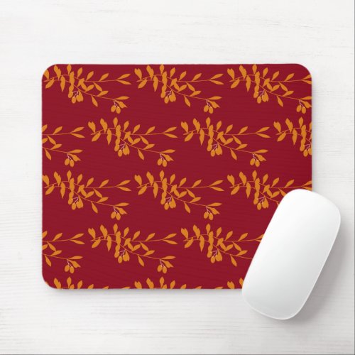 Orange silhouette branch leaves on red mouse pad