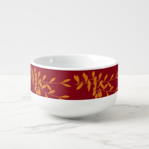 Orange silhouette branch leaves on red soup mug