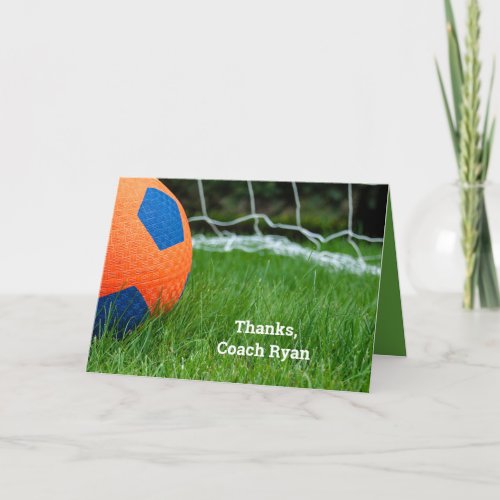 Orange soccer ball on grass card