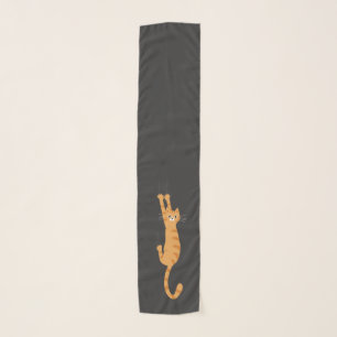 Orange Tabby Cat Hanging On Funny Striped Cat Scarf