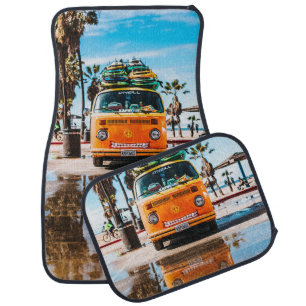 Orange van with surfboard on top car floor mat