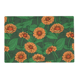 Orange Zinnia flowers, green leaves on dark green Placemat